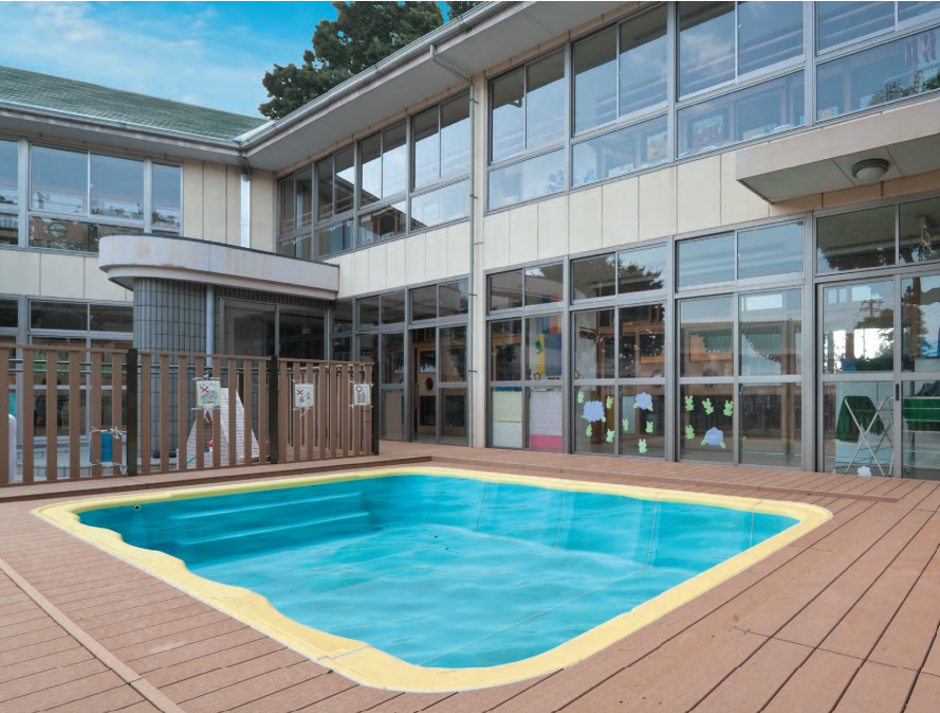 テクモク活用事例、幼稚園の屋外プールの周囲に、水に強い床材として施工されたプールデッキ